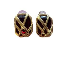 Vintage gold tone earrings with a red Gem in the middle